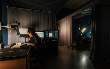 Behind the scenes view of NLI staff working on digitisation projects.