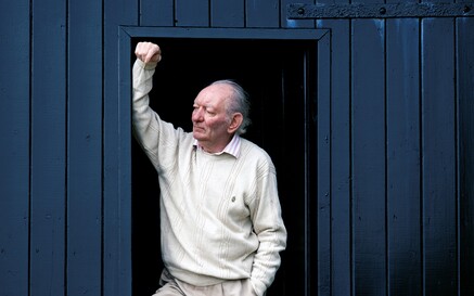 brian friel at his boathouse, standing in the doorway